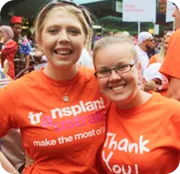Transplant recipients in orange shirts celebrating